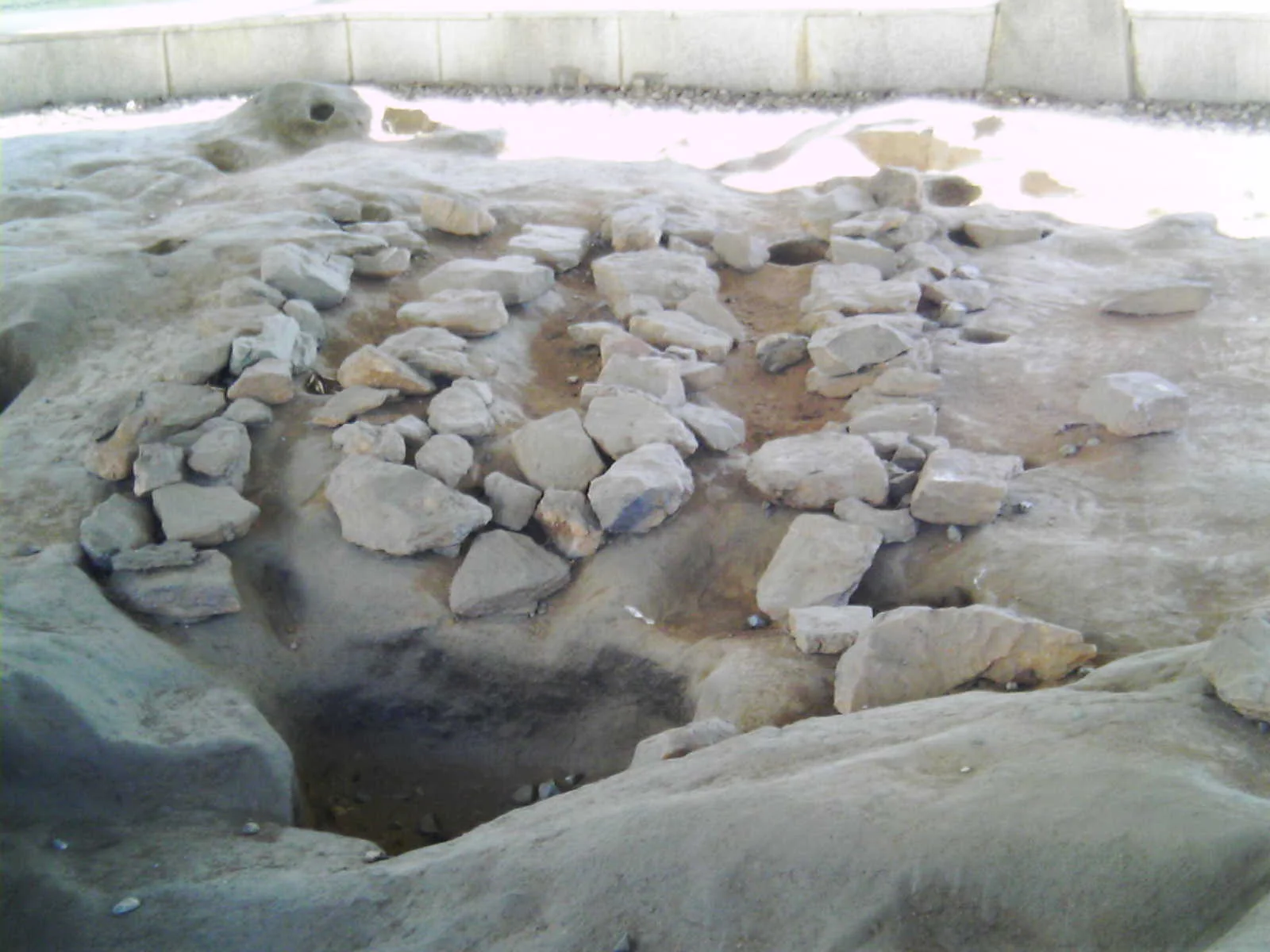 Museum reconstruction of a Baekje-period ondol site with stones outlining an underfloor heating passage
