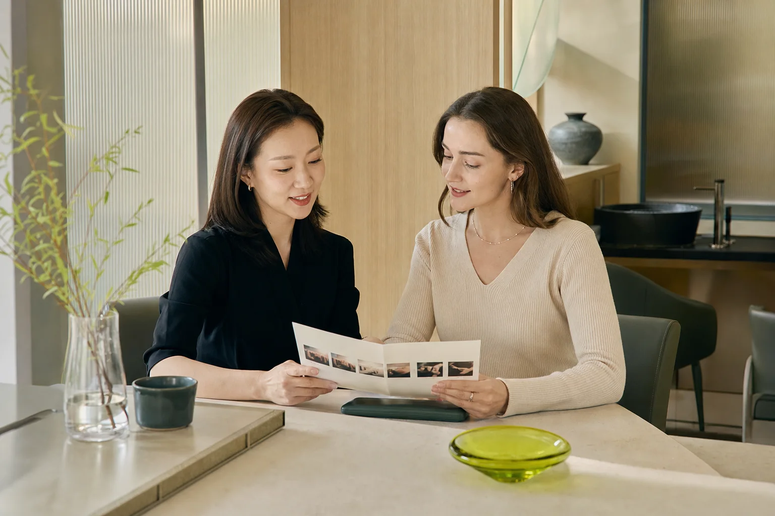 Korean stylist and international visitor reviewing a generic head-spa service sequence together as equal participants