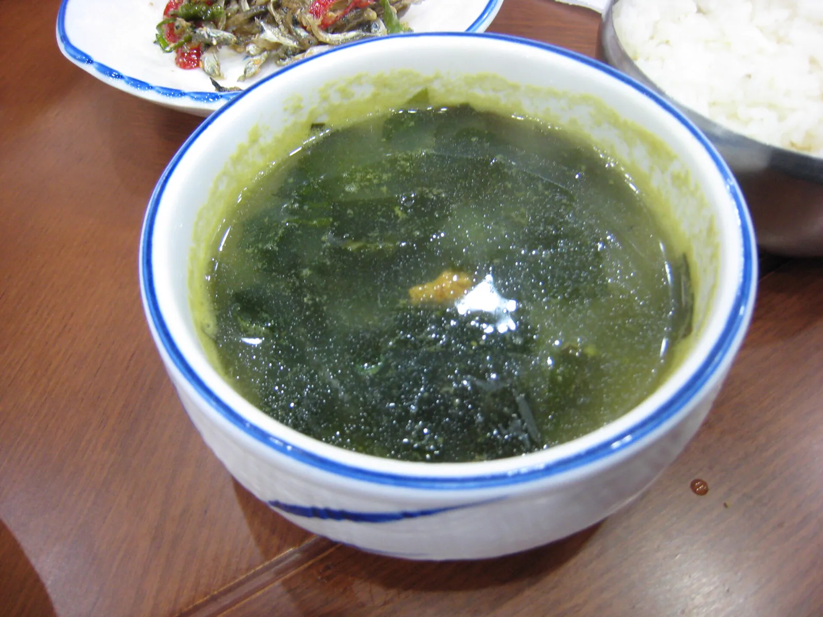 Bowl of Korean miyeokguk seaweed soup served with rice and small side dishes