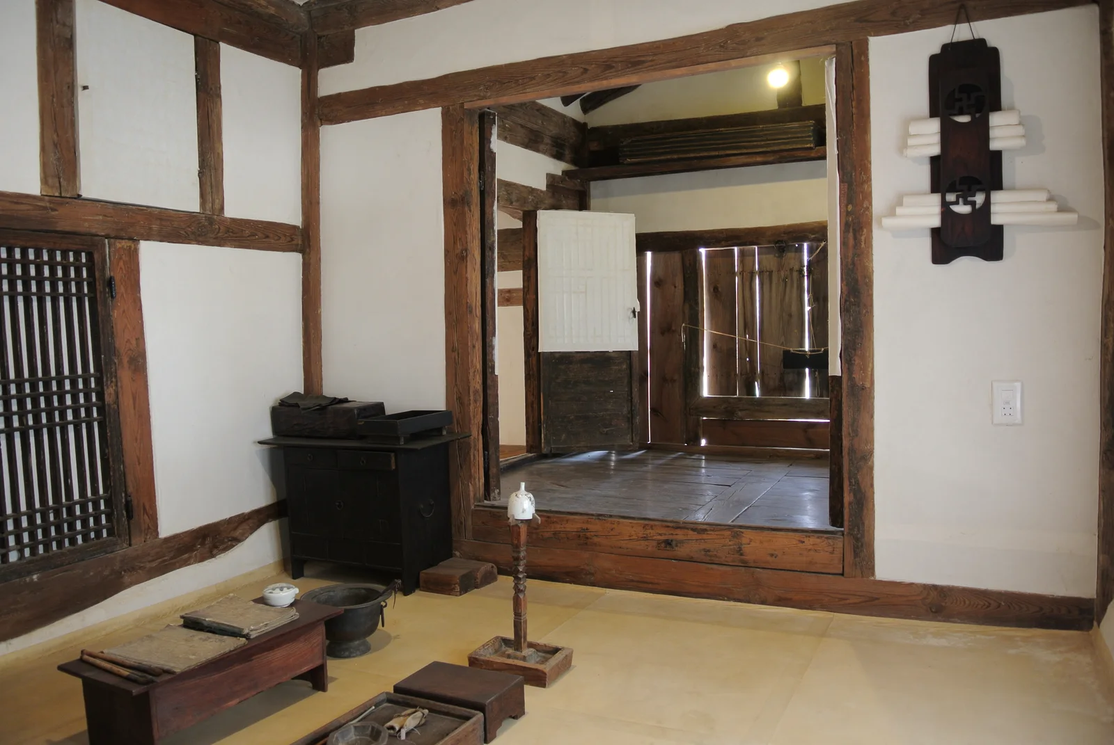 Reconstructed traditional Korean house interior with a clean floor-level room and low wooden furniture